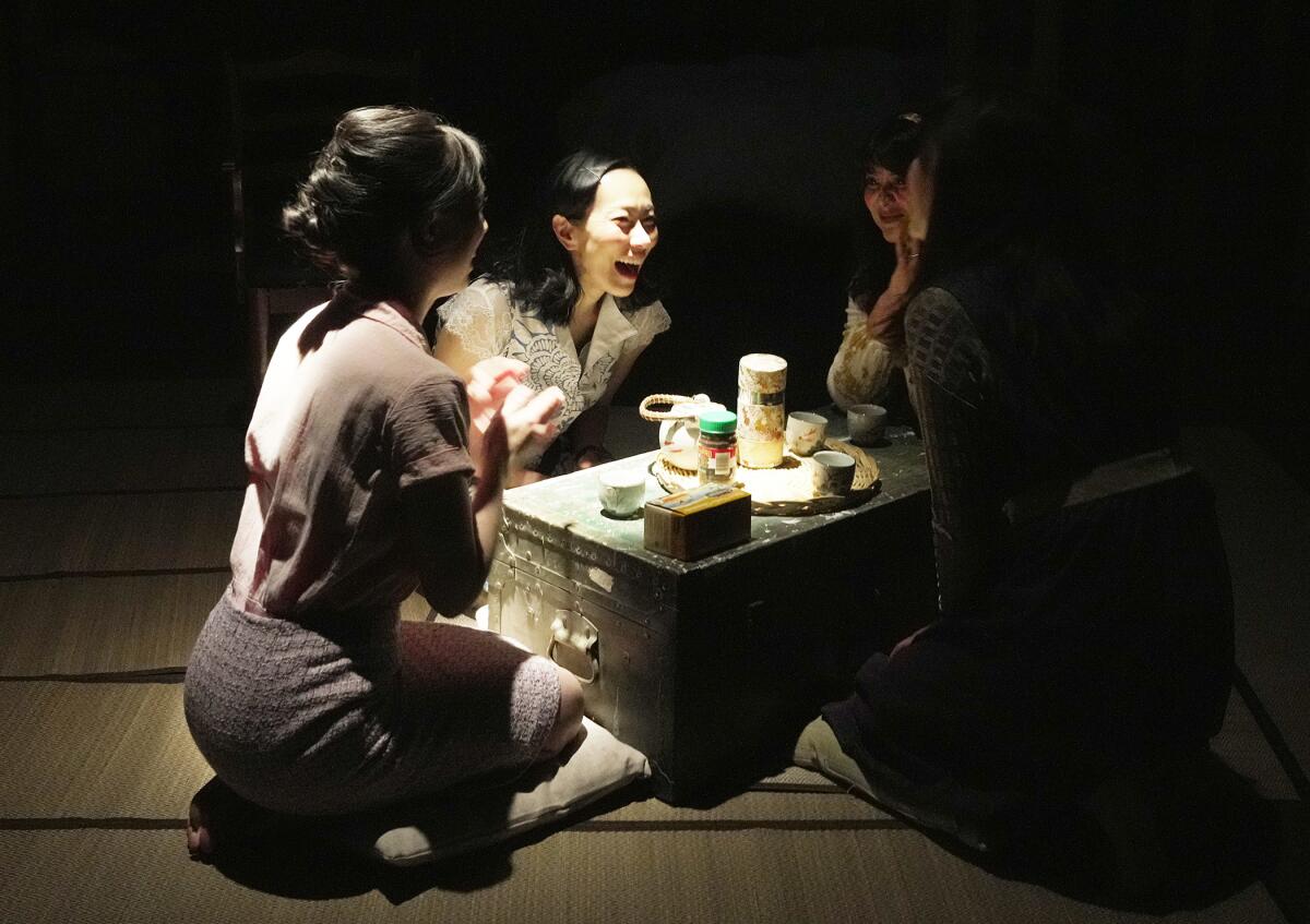 Four actors onstage share tea.