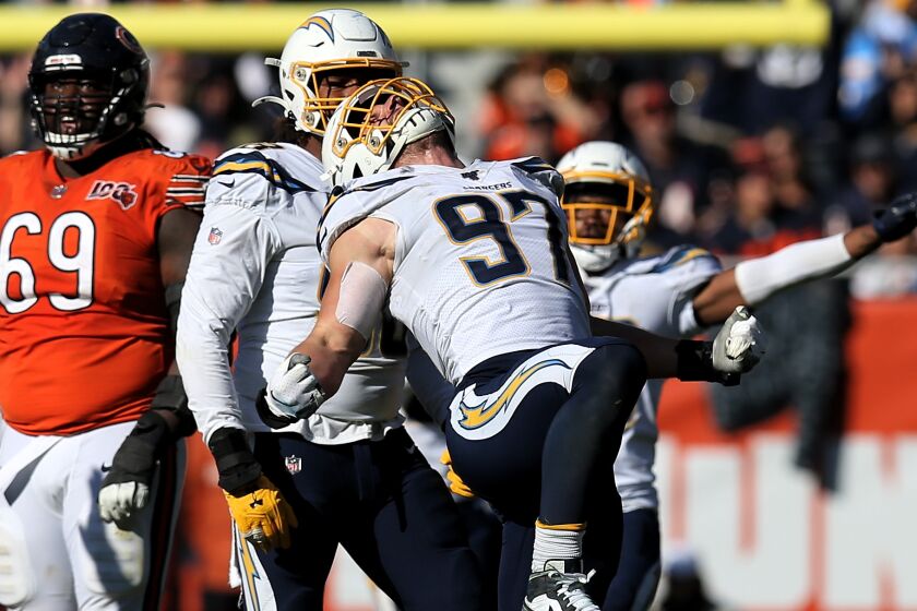 CHICAGO, ILLINOIS - OCTOBER 27: Joey Bosa #97 of the Los Angeles Chargers celebrates after making a sack in the fourth quarter against the Chicago Bears at Soldier Field on October 27, 2019 in Chicago, Illinois. (Photo by Dylan Buell/Getty Images)