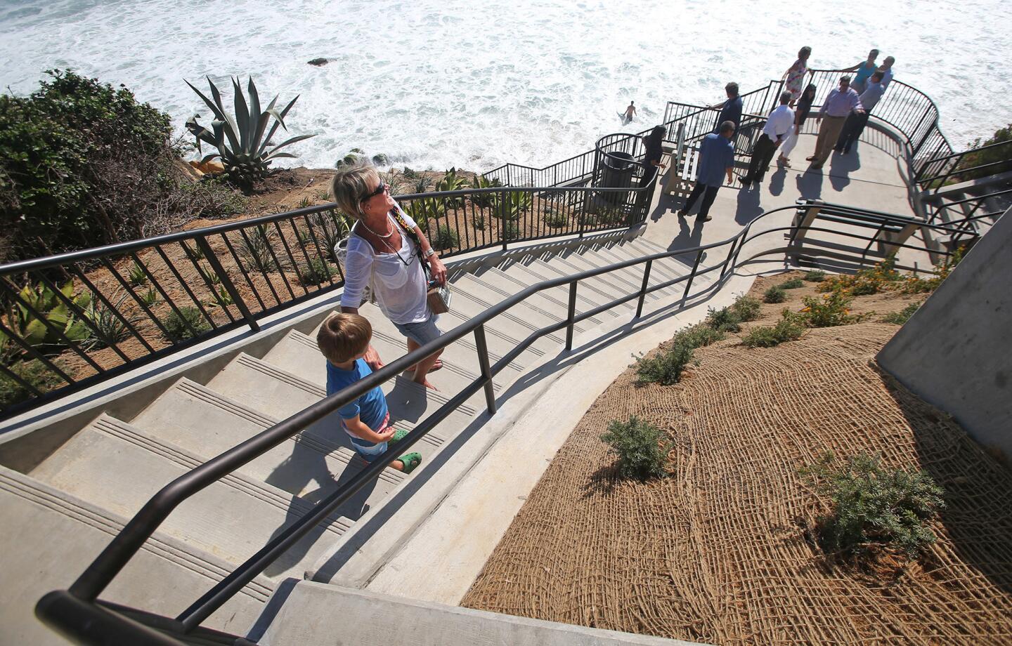 Jan Shoemaker makes her way down the stairs after an unveiling ceremony for the Agate Street Beach access improvement project Tuesday in Laguna Beach. The renovation includes new viewpoints and wider stairs.