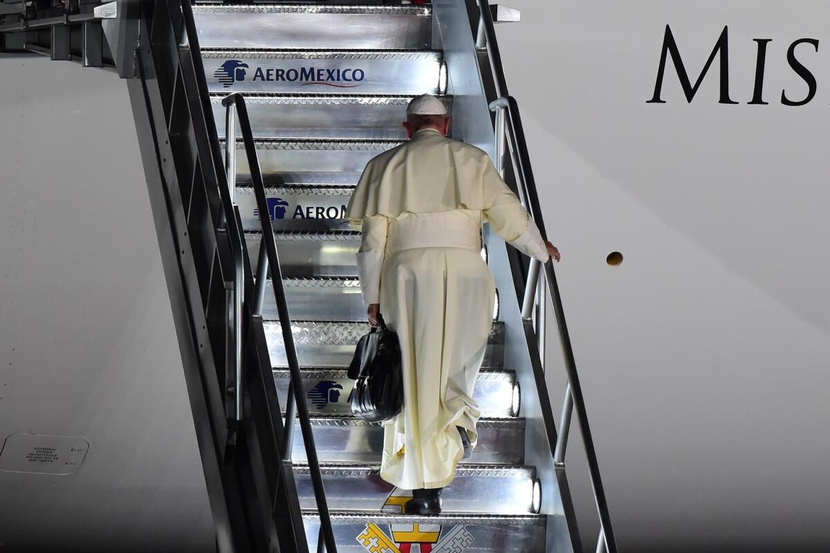 Pope Francis boards a plane for Rome.