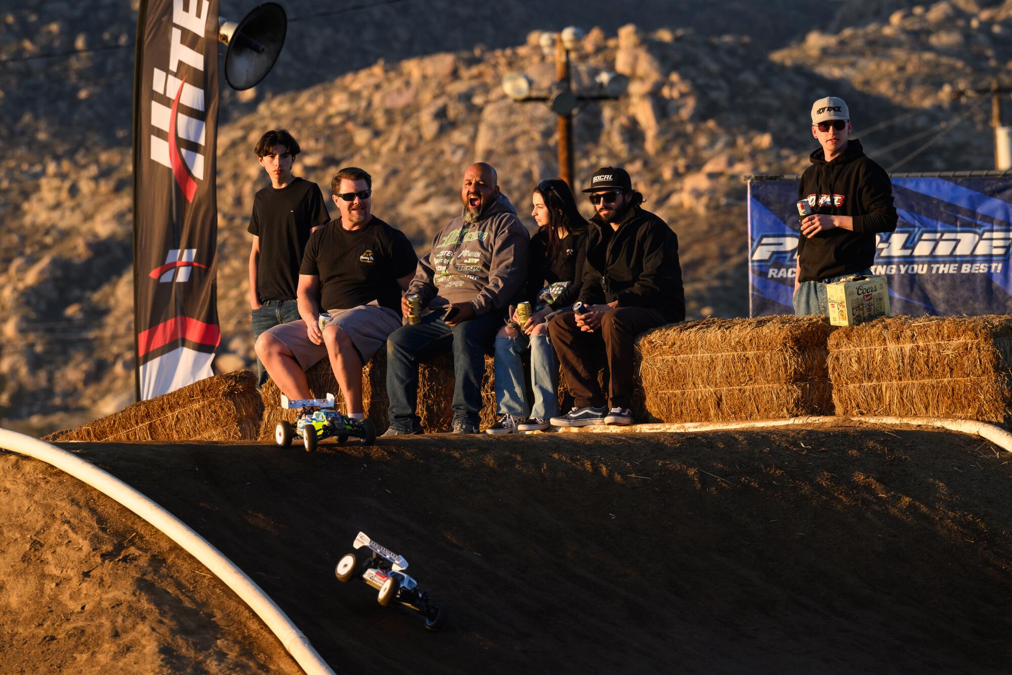 Fans react as they watch RC cars race down the track