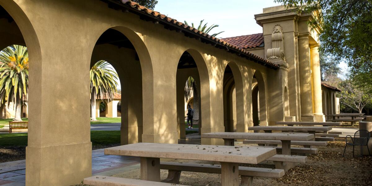 Empty chairs and tables sit outside the usually bustling student union at Stanford University.