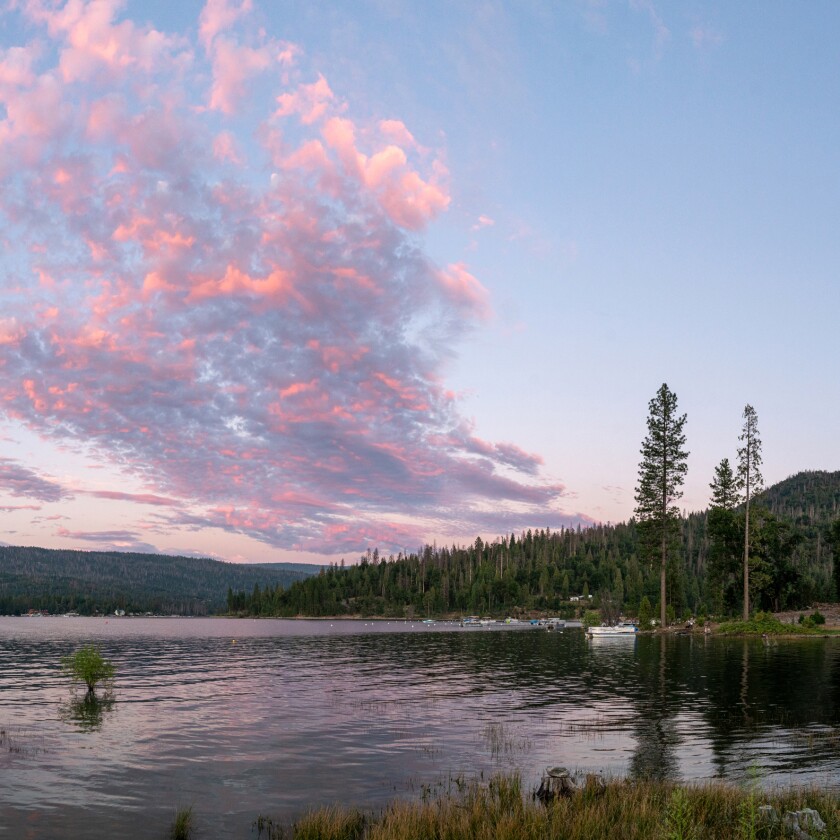 Photo of a lake with pinkish clouds above