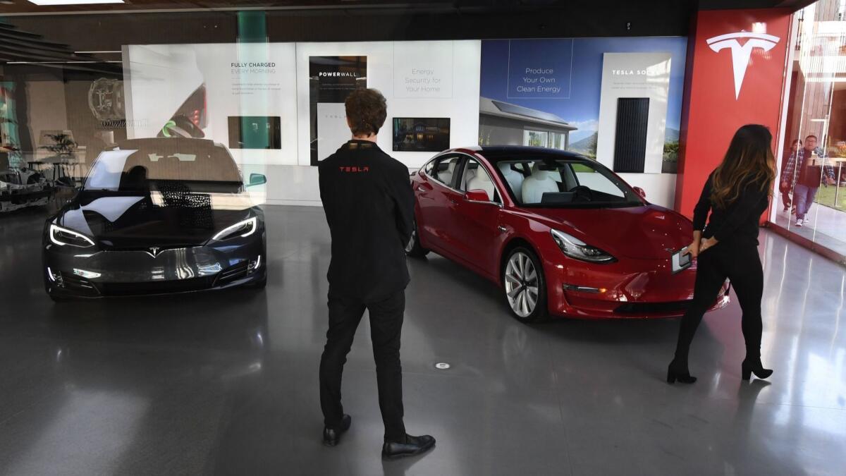 Tesla suggested bricks-and-mortar retail was important in its annual report filed nine days before Chief Executive Elon Musk announced a pivot to online sales. Above, a Tesla showroom.