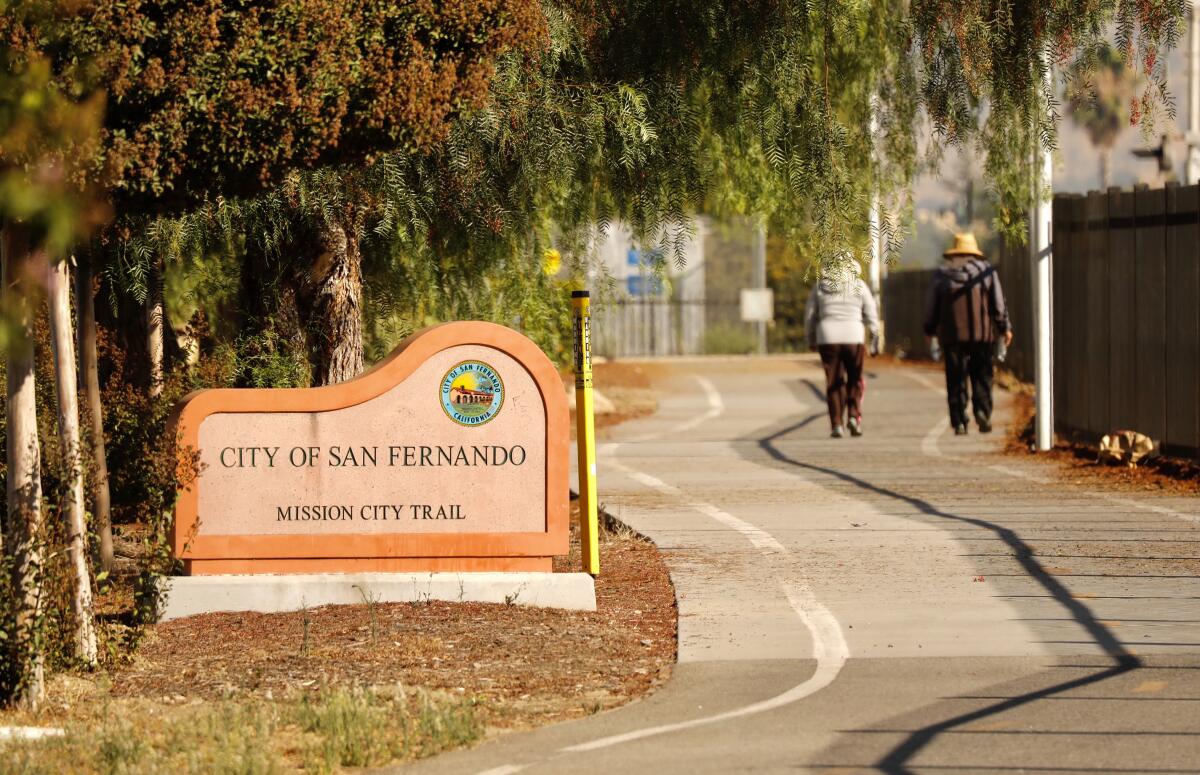 People walk along the Mission City Train in San Fernando, where a magnitude 4.2 earthquake struck early Thursday.