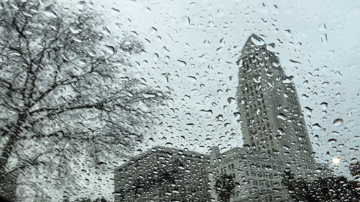 Los Angeles City Hall seen through a rain-covered window.