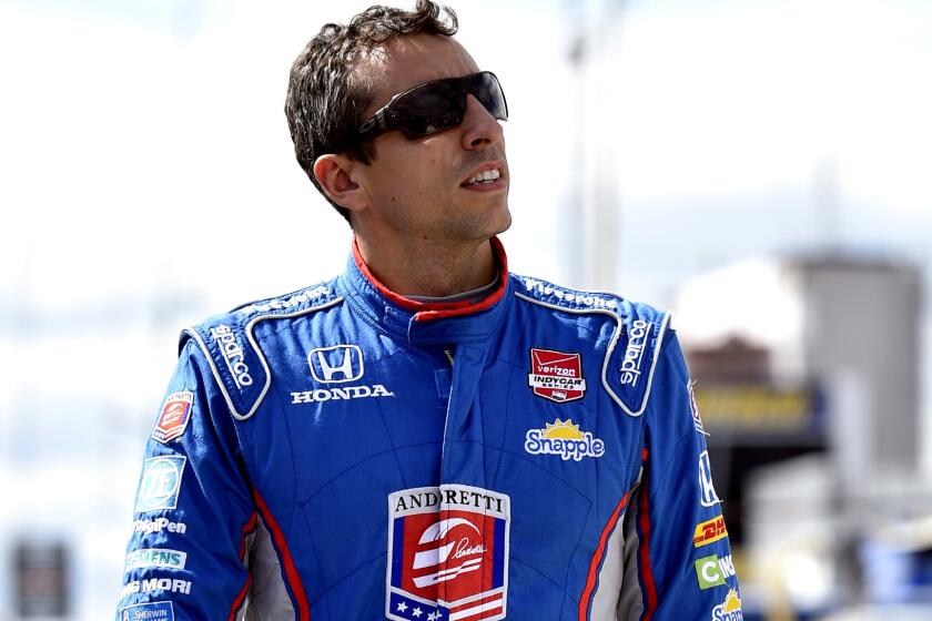 Justin Wilson walks on pit road during qualifying for the IndyCar race at Pocono.