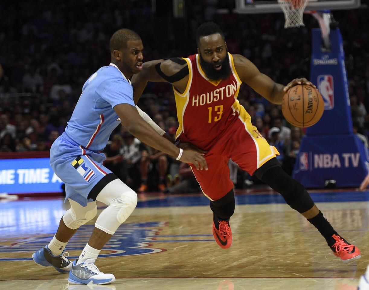 Rockets shooting guard James Harden drives by Clippers point guard Chris Paul in the fourth quarter. Harden scored 34 point in a two-point victory.