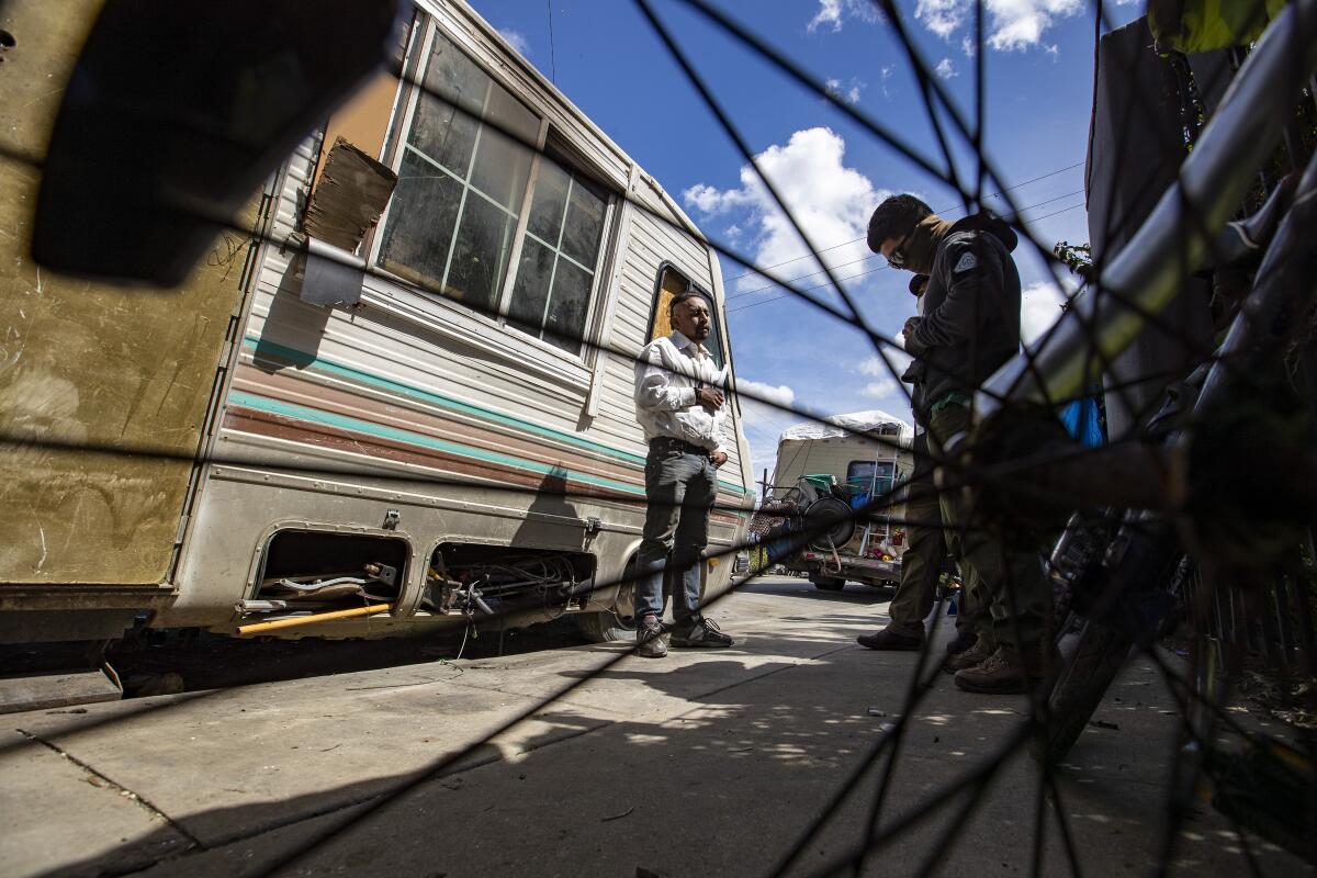 Outreach workers with St. Joseph Center talks with man who lives in RV