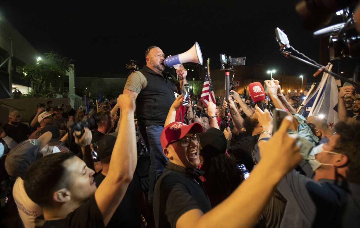 Far-right radio host and conspiracy theorist Alex Jones rallies a crowd of Trump supporters in Phoenix.