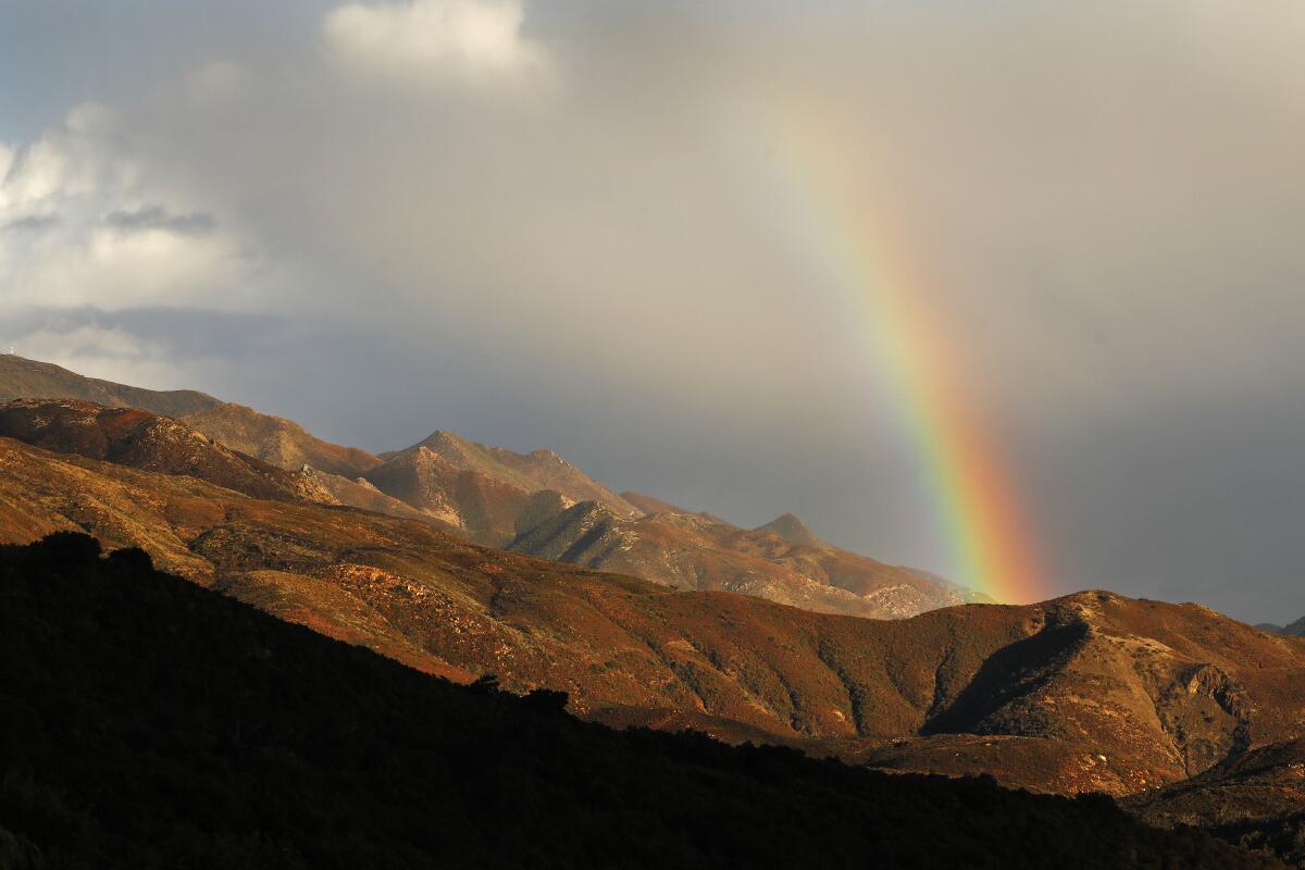 Saturday afternoon's rain from the first of several wet storm systems creates a rainbow over the Santa Ynez Mountains