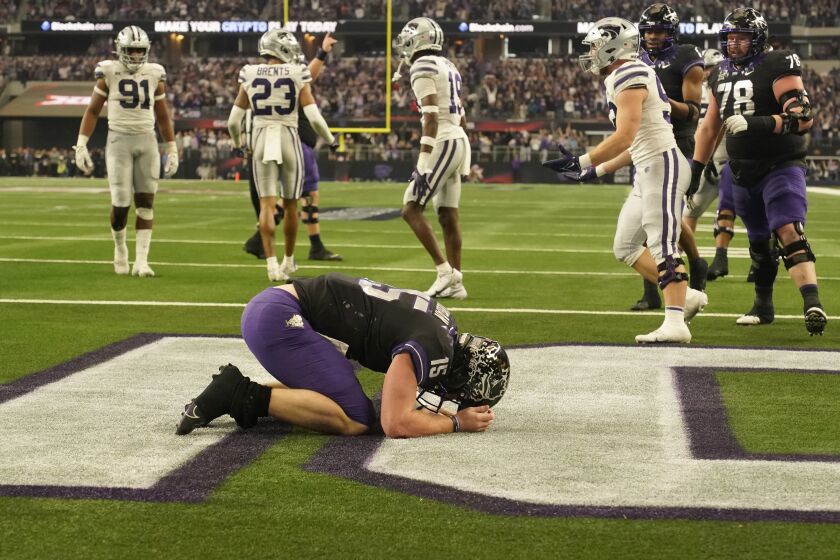 TCU quarterback Max Duggan (15) kneels in the end zone after rushing for a touchdown in the second half of the Big 12 Conference championship NCAA college football game against Kansas State, Saturday, Dec. 3, 2022, in Arlington, Texas. (AP Photo/LM Otero)