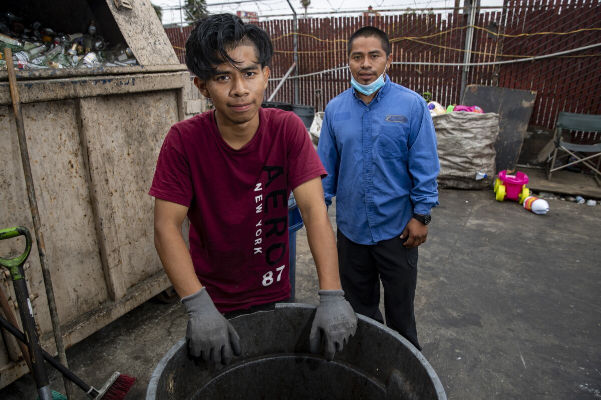 Gadseel Quiñonez and his brother Jose Quiñonez at the recycling center where they work. 