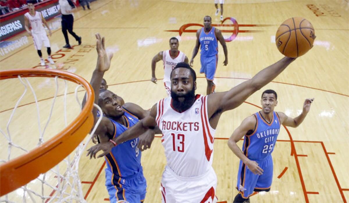 Houston's James Harden dunks over Oklahoma's Serge Ibaka during the Rockets' 73-point first half. The Thunder defeated the Rockets, 104-92
