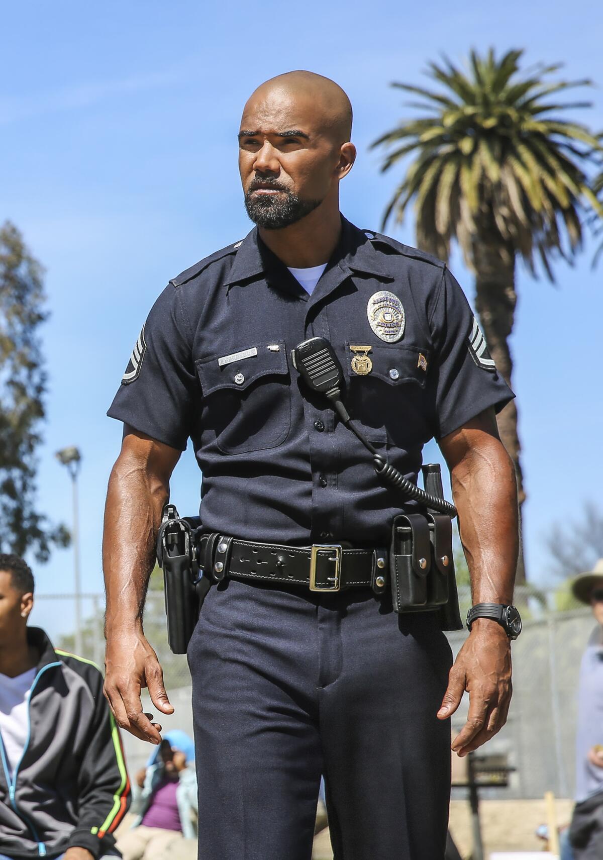 An actor is dressed in a police uniform in a scene from the TV show 'S.W.A.T.'