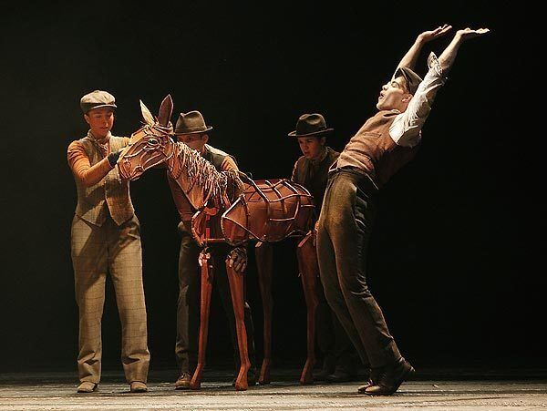Andrew Veenstra celebrates the purchase of the young foal he calls Joey in the Tony-winning play "War Horse" at the Ahmanson Theatre. Puppeteers are, from left, Laurabeth Breya, Catherine Gowl and Nick Lamedica.