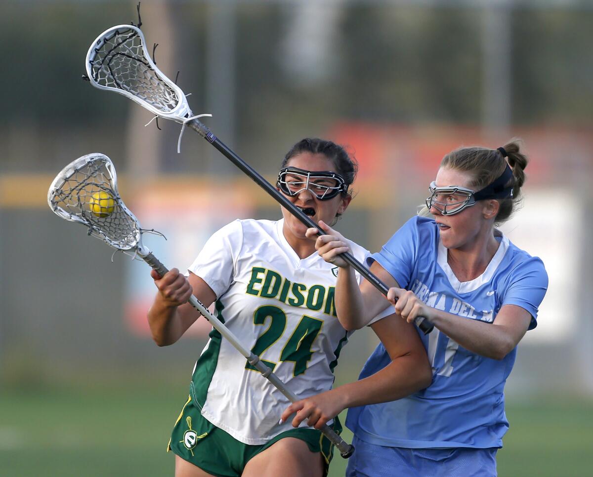 Edison's Brooklynn Peters (24) tries to break through the defense of CdM's Abby Grace (11) during Tuesday's match.