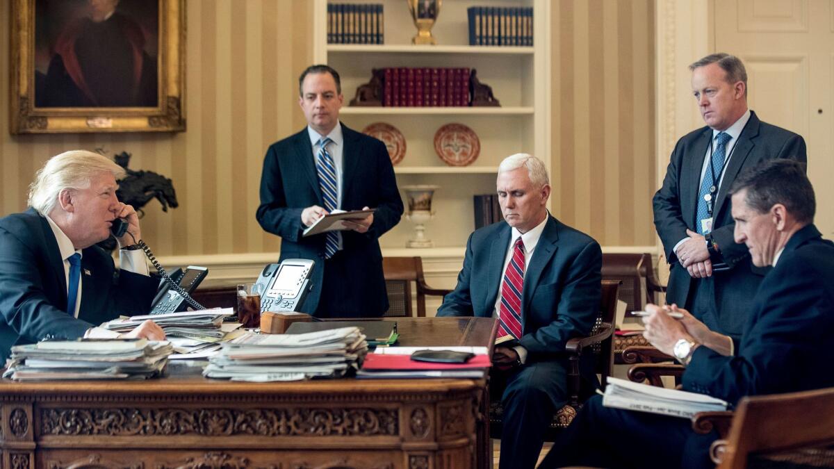 President Trump and his inner circle, (with recently resigned national security advisor Michael Flynn on the far right) speaks on the phone with Russian President Vladimir Putin in the Oval Office on Jan. 28.