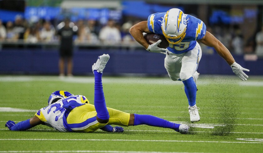The Chargers' Michael Bandy gets past the Rams' defensive back.