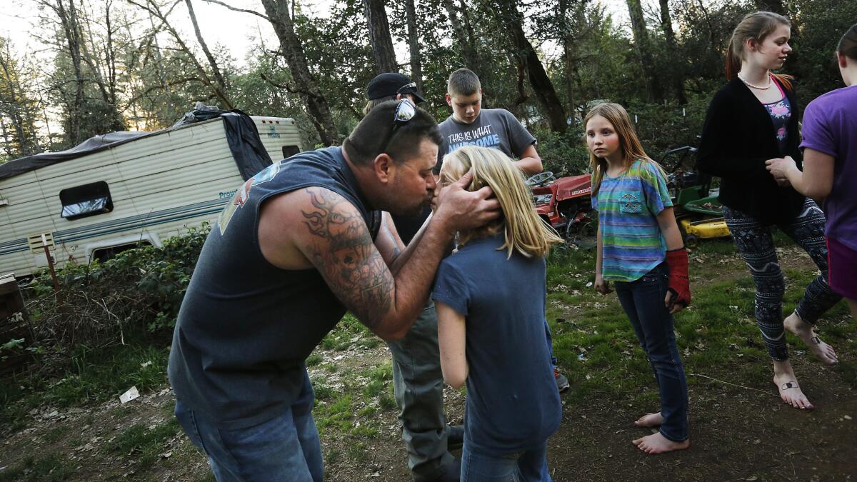 Keven Jones greets daughter Emilee upon his return home from a trip to town.