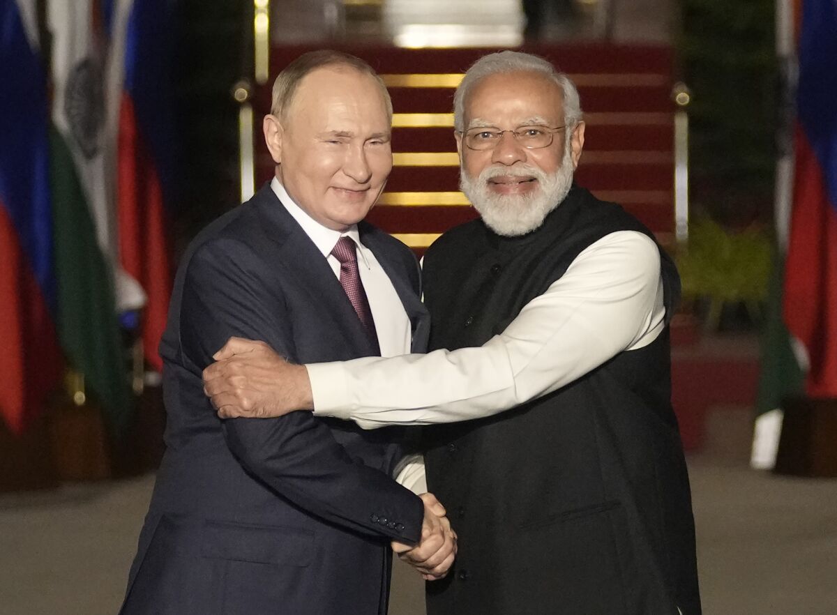 FILE - Russian President Vladimir Putin, left, and Indian Prime Minister Narendra Modi greet each other before their meeting in New Delhi, India on Dec. 6, 2021. India is bracing for a disruption in Russian arms supplies following Moscow's invasion of Ukraine, and Prime Minister Narendra Modi's tightrope walk between Moscow and Washington could become more difficult due to a border standoff with China. (AP Photo/Manish Swarup, File)