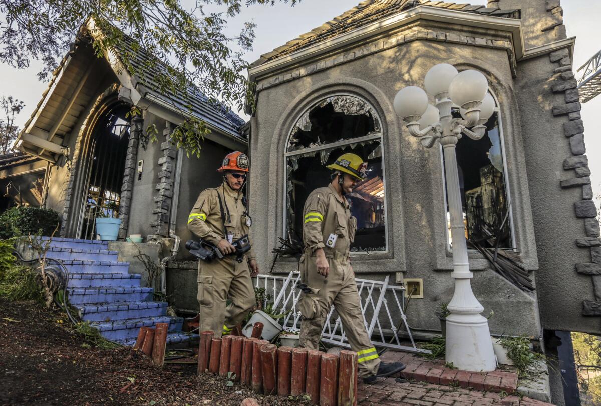 Los Angeles Fire Department search-and-rescue teams comb through a Mt. Washington home that burned Oct. 20.