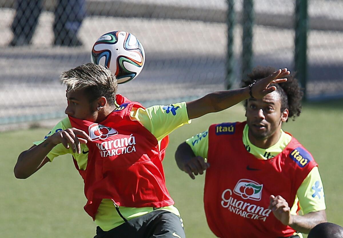 Brazilian teammates Neymar and Marcelo Viera, right, practice on Friday in a training session in Belo Horizonte, Brazil.