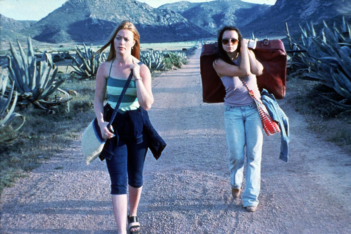 Kathleen McDermott, left, and Samantha Morton walk on an empty dirt road in “Morvern Callar.”