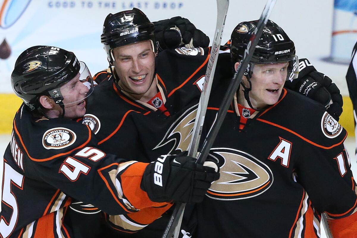 Ducks center Ryan Getzlaf, center, celebrates with defenseman Sami Vatanen (45) and right wing Corey Perry after scoring the game's final goal in a 4-2 victory over the Jets on Thursday night in Anaheim.