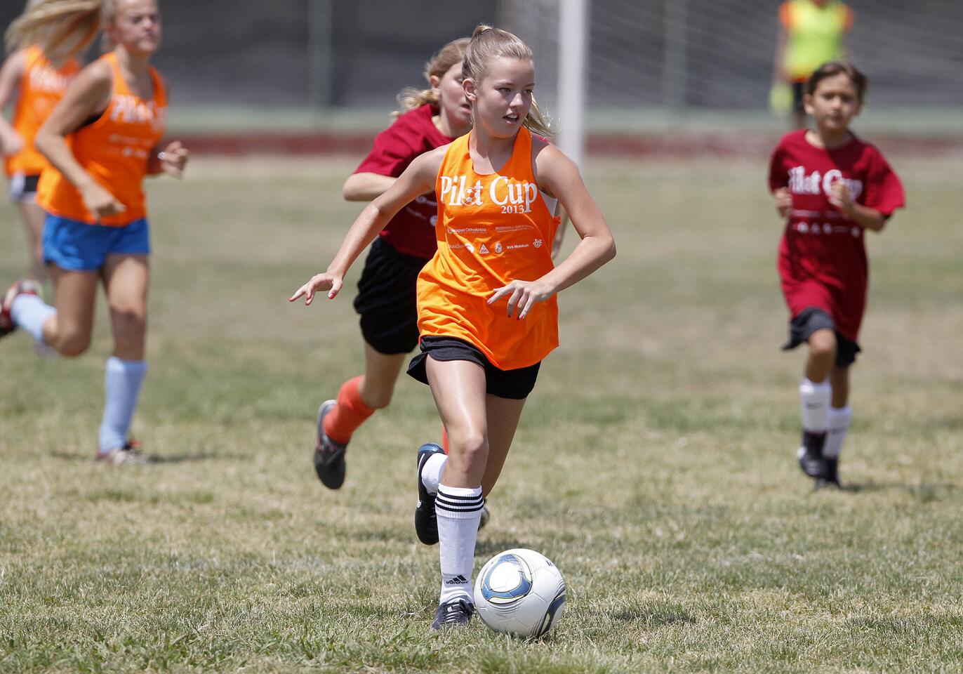 Mariners Elementary's Ali Woodward, center, dribbles the ball to Christ Lutheran's goal before scoring one for her team during a Daily Pilot Cup girls' 5-6 bronze division quarterfinal game on Saturday.