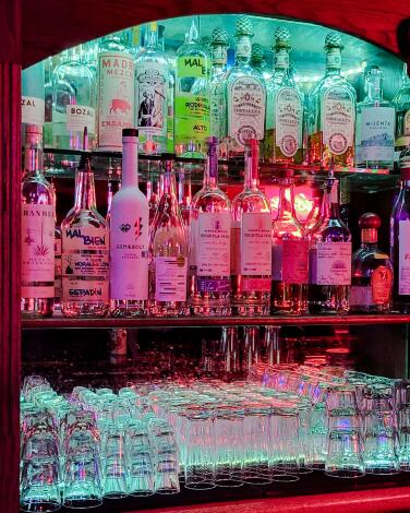 Three shelves of liquor bottles at the bar Frank N Hank in Koreatown.