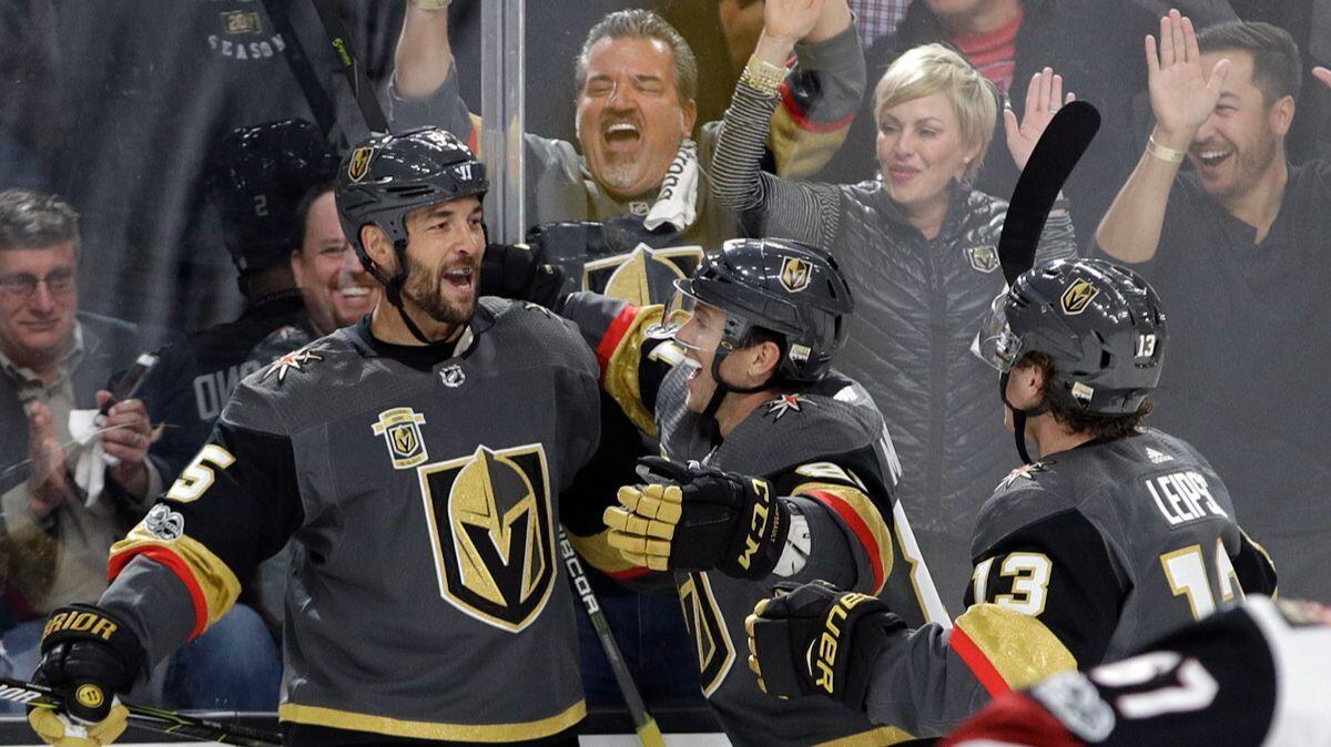 Vegas Golden Knights defenseman Deryk Engelland, left, celebrates after scoring against the Arizona Coyotes during the first period on Tuesday.