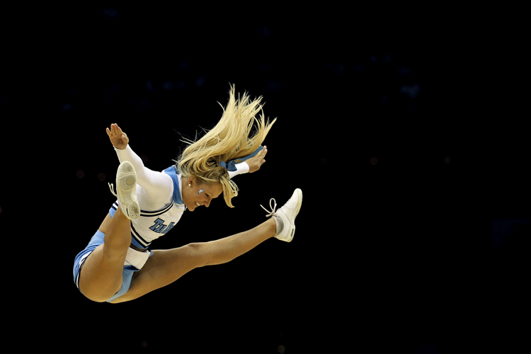 A North Carolina Tar Heels cheerleader performs while playing the Kentucky Wildcats in the east regional final of the 2011 NCAA men's basketball tournament.