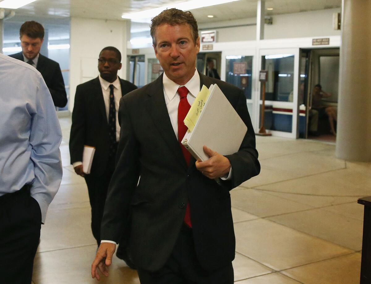 Sen. Rand Paul (R-Ky.) walks to the Capitol where he tried but failed to delay a vote on the nomination of David Barron to fill a seat on the U.S. 1st Circuit Court of Appeals on Wednesday.