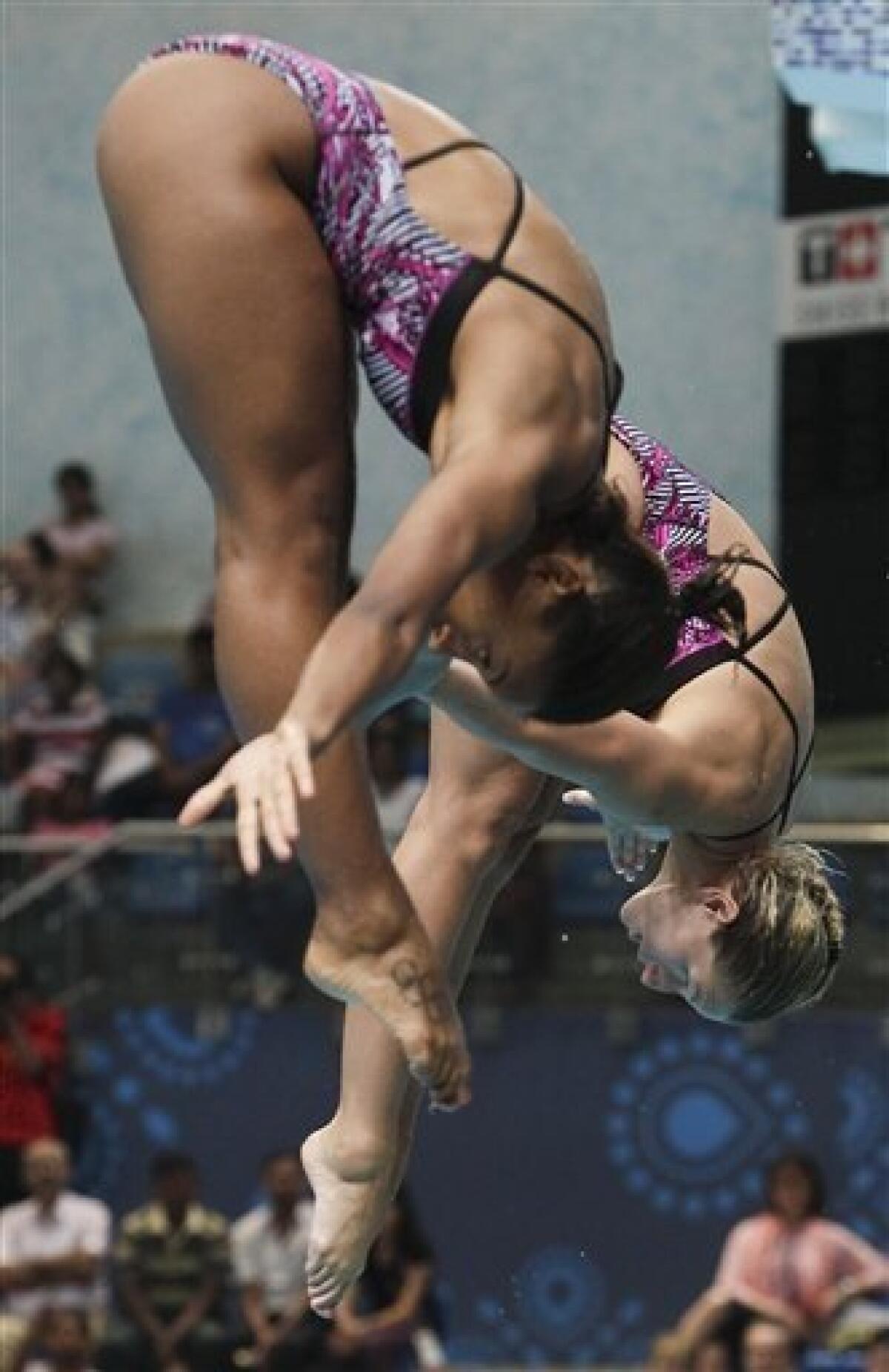 Canada's Jennifer Abel and Emile Heymans compete in the women's 3m springboard final to win the gold during the Commonwealth Games at the Dr. S.P. Mukherjee Aquatics Center in New Delhi, India, Sunday, Oct. 10, 2010. (AP Photo/Domenico Stinellis)