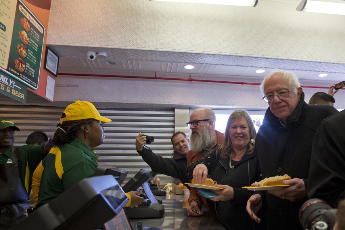 Democratic presidential candidate Bernie Sanders, wife Jane and musician Michael Stipe get hot dogs at Nathan's Famous in Coney Island last weekend.