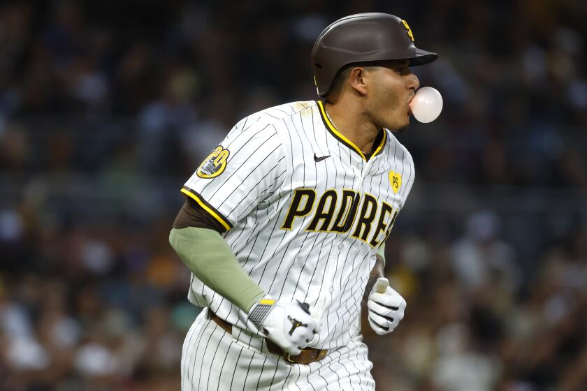 San Diego CA - May 14: San Diego Padres' Manny Machado blows a bubble as he runs to first base after hitting a single against the Colorado Rockies in the fourth inning at Petco Park on Tuesday, May 14, 2024 in San Diego, CA. (K.C. Alfred / The San Diego Union-Tribune)