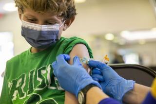 Brody Haber, 8, gets his COVID-19 booster at a vaccination clinic hosted by Los Angeles County Public Health at Balboa Sports Complex in Encino, Calif., on Saturday May 21, 2022. COVID-19 booster shots are now available for children ages 5-11 in Los Angeles County and LA County Public Health is encouraging parents to bring eligible children to vaccination sites to get boosted before summer vacation and holiday travel. (Alisha Jucevic/For The Times)