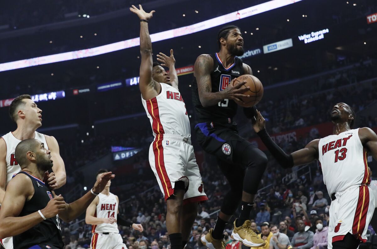 Clippers guard Paul George drives past Miami Heat guard Kyle Lowry.