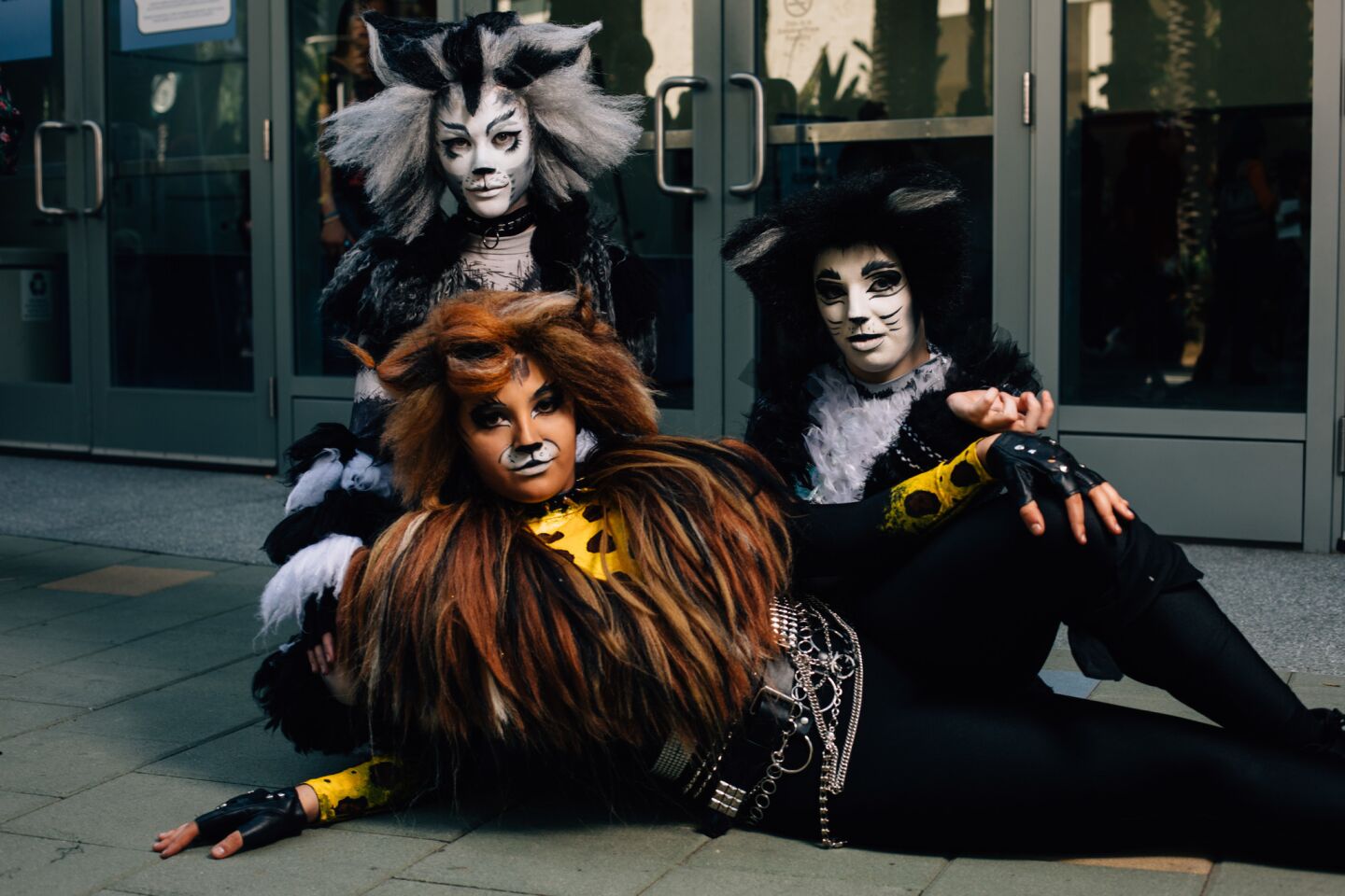 Cosplaying as cats from the musical “Cats,” Hudson Hawk Pritchard, Lily Rodriguez and Rebecca Rose Gibson strike a pose at WonderCon 2019.