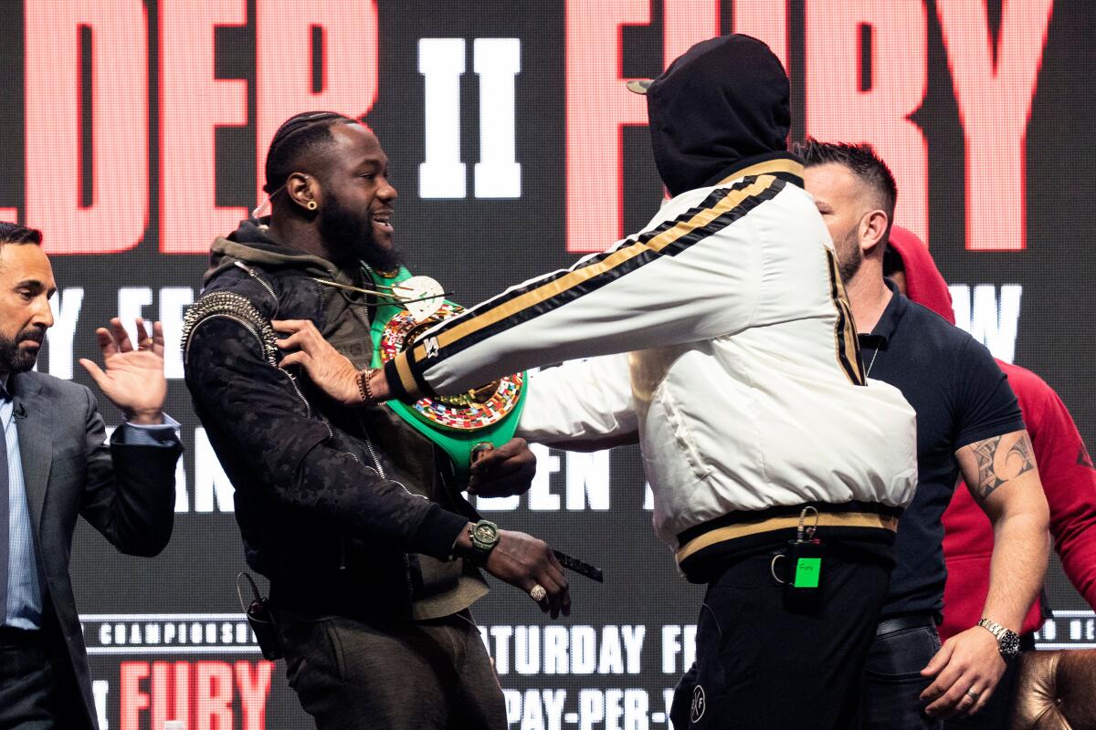 Mandatory Credit: Photo by ETIENNE LAURENT/EPA-EFE/REX (10561906a) Heavyweight US boxer Deontay Wilder (2-L) and heavyweight British boxer Tyson Fury II (R) push each other on stage prior to their last press conference before their rematch for the WBC Heavyweight World Championship at the Garden Arena in Las Vegas, Nevada, USA, 19 February 2020. The WBC Heavyweight World Championship fight between Wilder and Fury is schedule for 22 February 2020. Deontay Wilder vs Tyson Fury II - Presser, Las Vegas, USA - 19 Feb 2020 ** Usable by LA, CT and MoD ONLY **