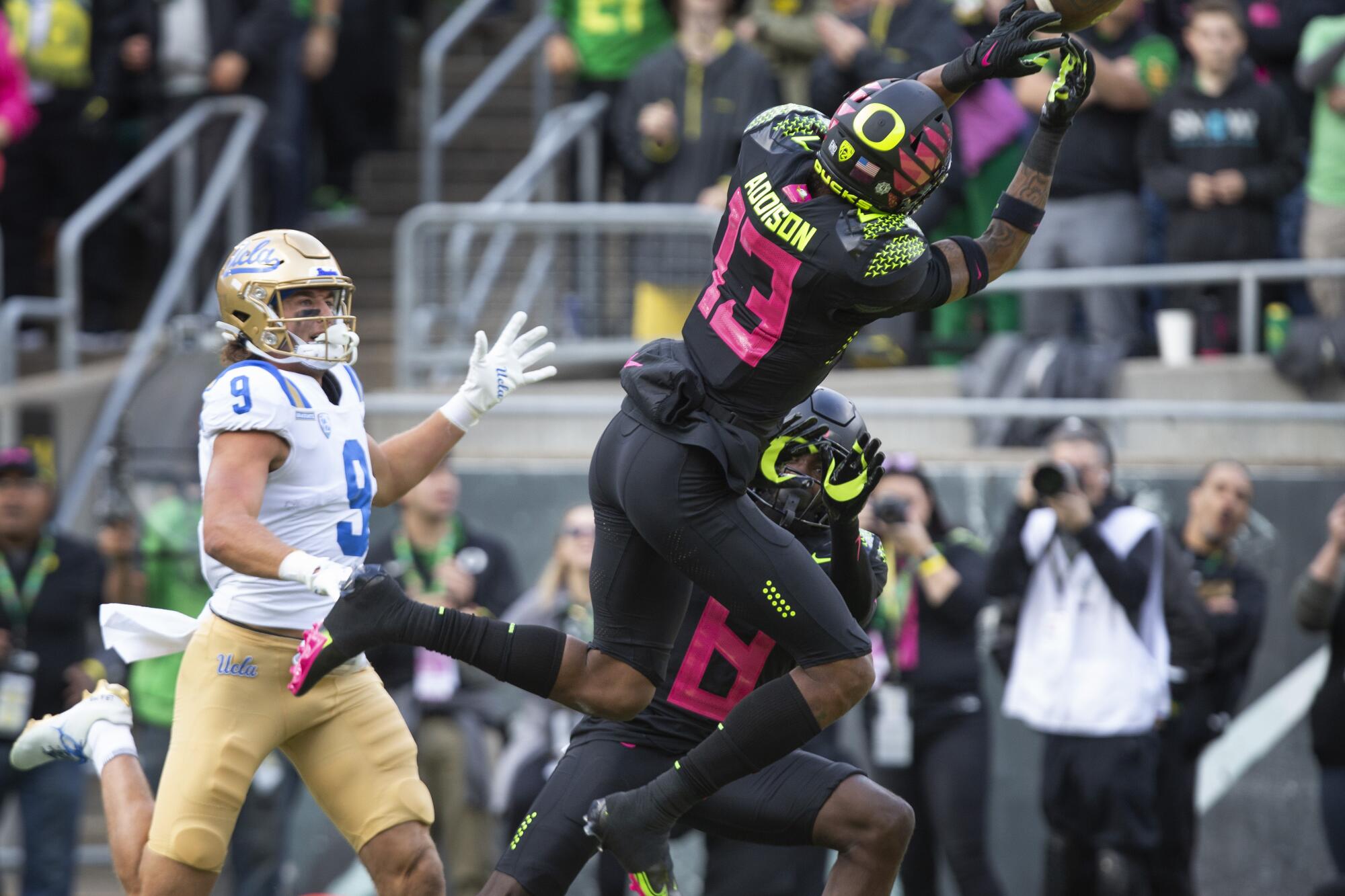 Oregon's Bryan Addison breaks up a pass play in the end zone intended for UCLA's Jake Bobo.