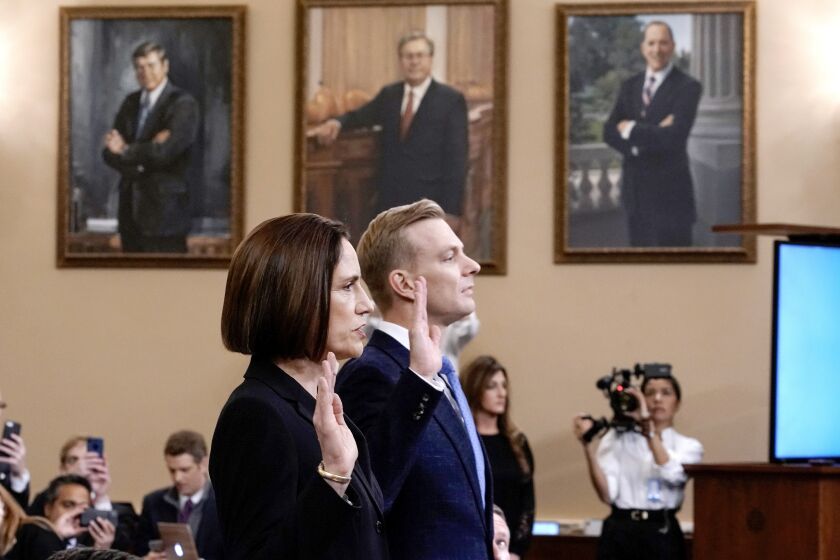 Former White House national security aide Fiona Hill, left, and David Holmes, a U.S. diplomat in Ukraine, are sworn in to testify before the House Intelligence Committee on Capitol Hill in Washington, Thursday, Nov. 21, 2019, during a public impeachment hearing of President Donald Trump's efforts to tie U.S. aid for Ukraine to investigations of his political opponents. (AP Photo/J. Scott Applewhite)