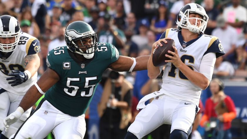 Rams quarterback Jared Goff avoids a sack as he gets pressure from Eagles defensive end Brandon Graham at the Coliseum when the two teams met last season.