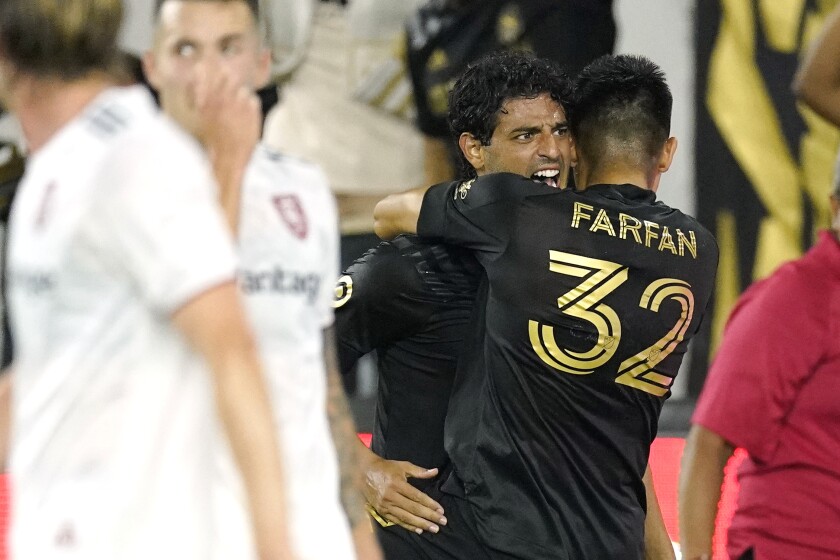 LAFC's Carlos Vela, second from right, celebrates his 79th-minute goal with defender Marco Farfan on July 17, 2021.