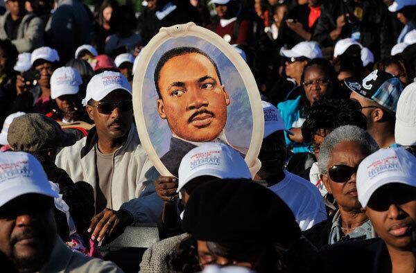 People hold a poster of MLK, Jr.