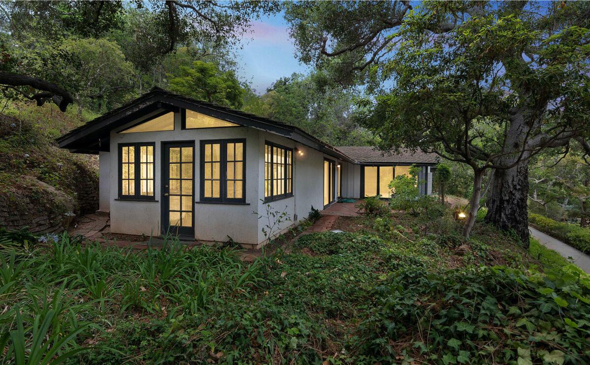 The single-story home is tucked into a leafy lot near Sullivan Canyon Park.