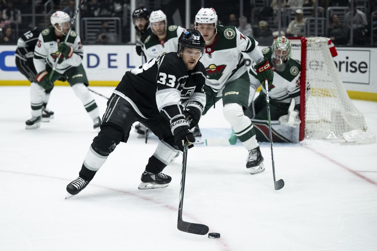 The Kings' Viktor Arvidsson reaches for the puck during Monday's game against Minnesota.