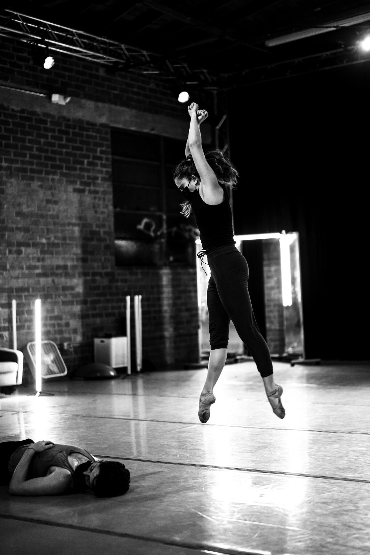 A dancer leaps with pointed toes.