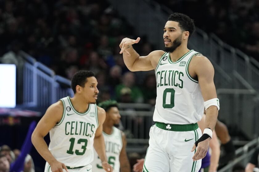 Boston Celtics' Jayson Tatum (0) gestures after making a 3-point basket during the second half of an NBA basketball game against the Milwaukee Bucks, Thursday, March 30, 2023, in Milwaukee. (AP Photo/Aaron Gash)